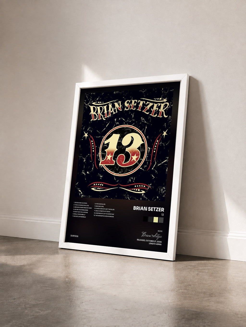#blanc Tableau de l'album 13 de Brian Setzer vu de trois quarts, cadre blanc
