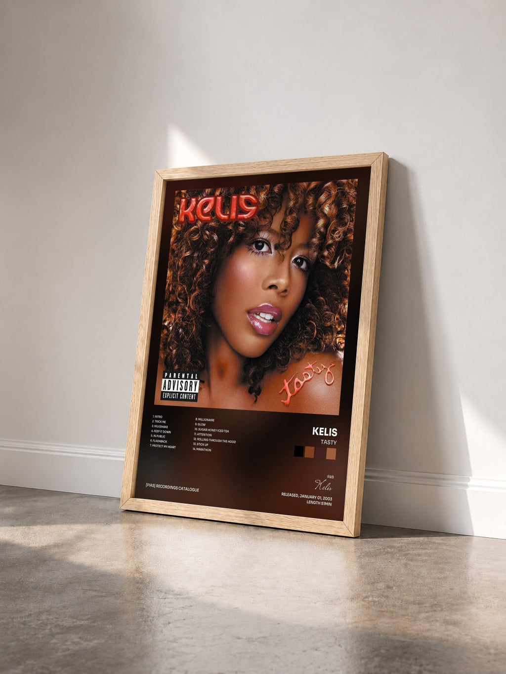 #bois Tableau de l'album Tasty de Kelis vu de trois quarts, cadre en bois brut