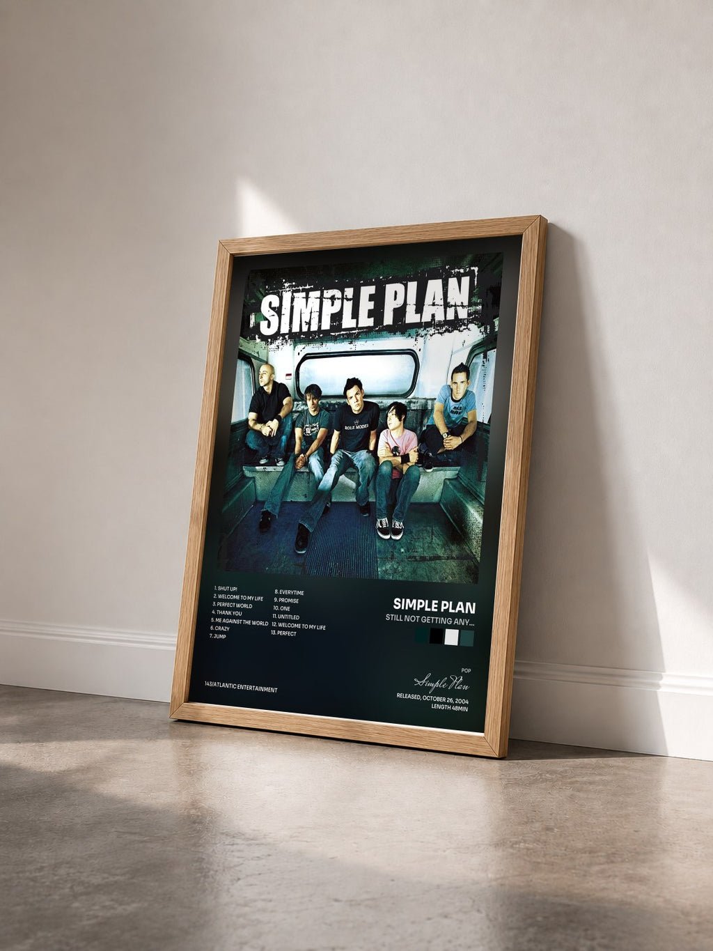 #bois Tableau de l'album Still Not Getting Any... de Simple Plan vu de trois quarts, cadre en bois brut