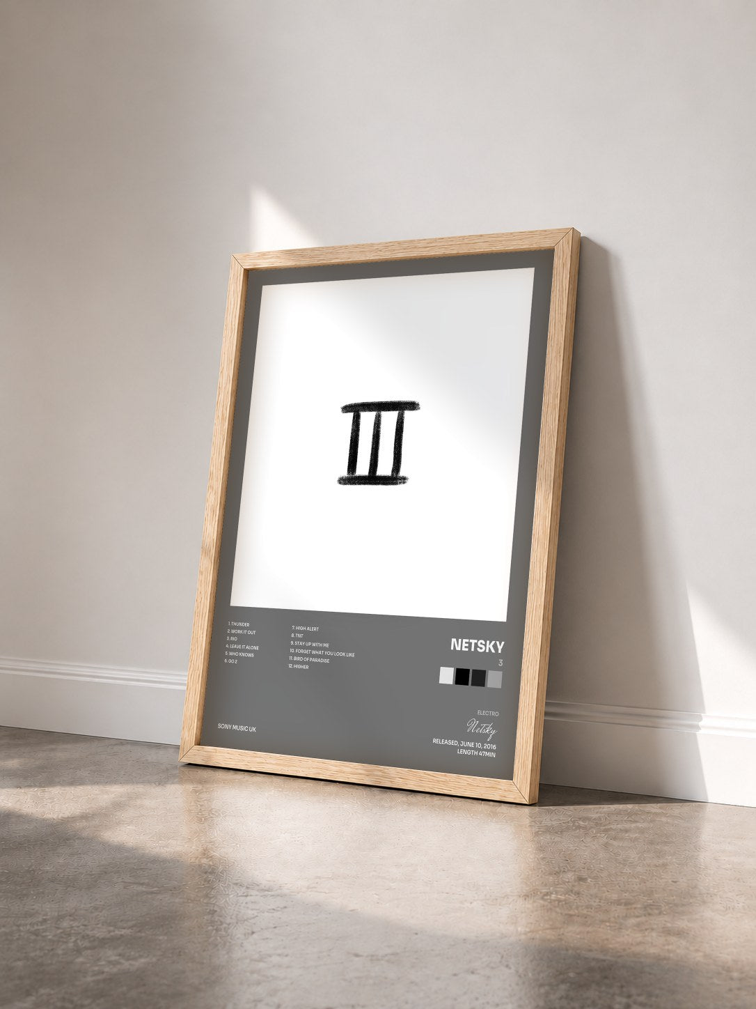 #bois Tableau de l'album 3 de Netsky vu de trois quarts, cadre en bois brut