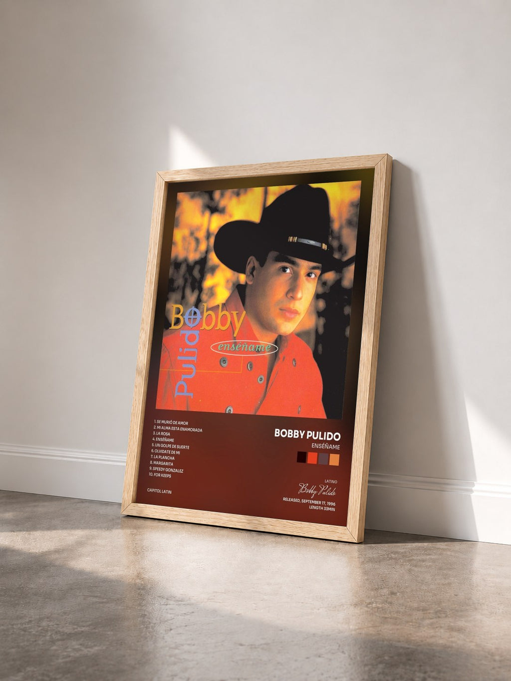 #bois Tableau de l'album Enséñame de Bobby Pulido vu de trois quarts, cadre en bois brut