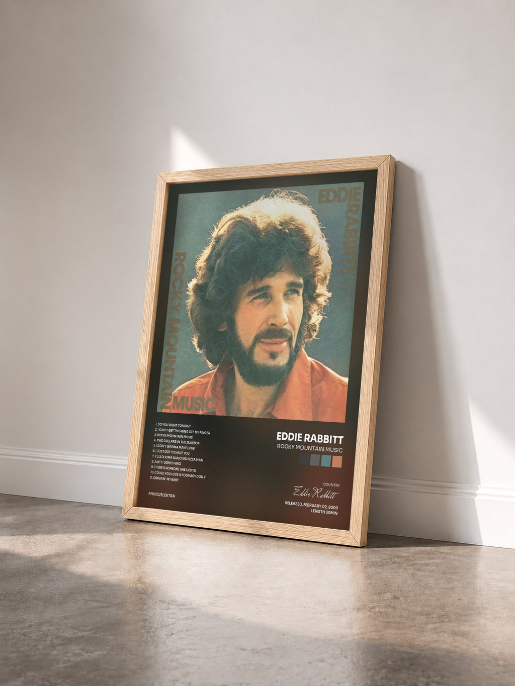 #bois Tableau de l'album Rocky Mountain Music de Eddie Rabbitt vu de trois quarts, cadre en bois brut