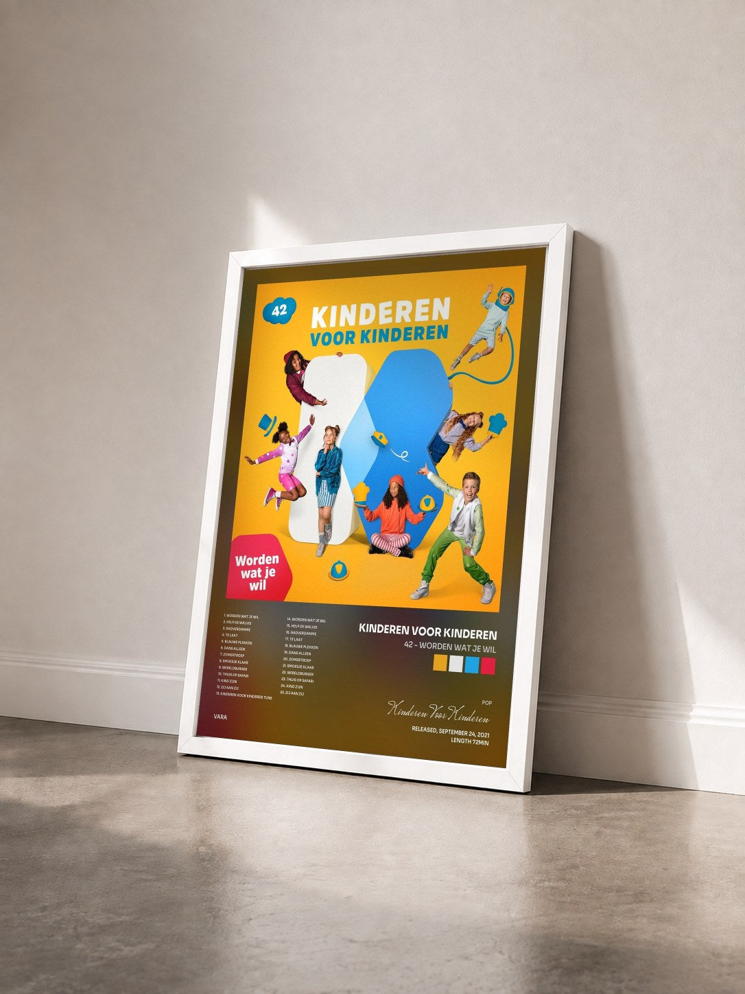 #blanc Tableau de l'album 42 - Worden wat je wil de Kinderen Voor Kinderen vu de trois quarts, cadre blanc