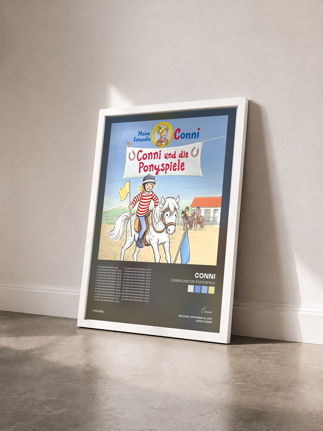 #blanc Tableau de l'album Conni und die Ponyspiele de Conni vu de trois quarts, cadre blanc