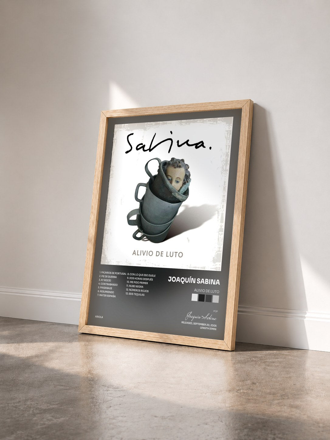 #bois Tableau de l'album Alivio De Luto de Joaquín Sabina vu de trois quarts, cadre en bois brut