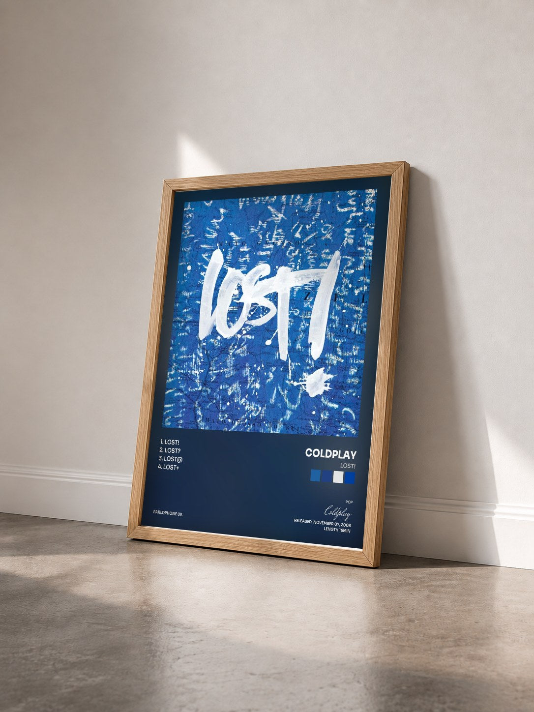 #bois Tableau de l'album Lost! de Coldplay vu de trois quarts, cadre en bois brut
