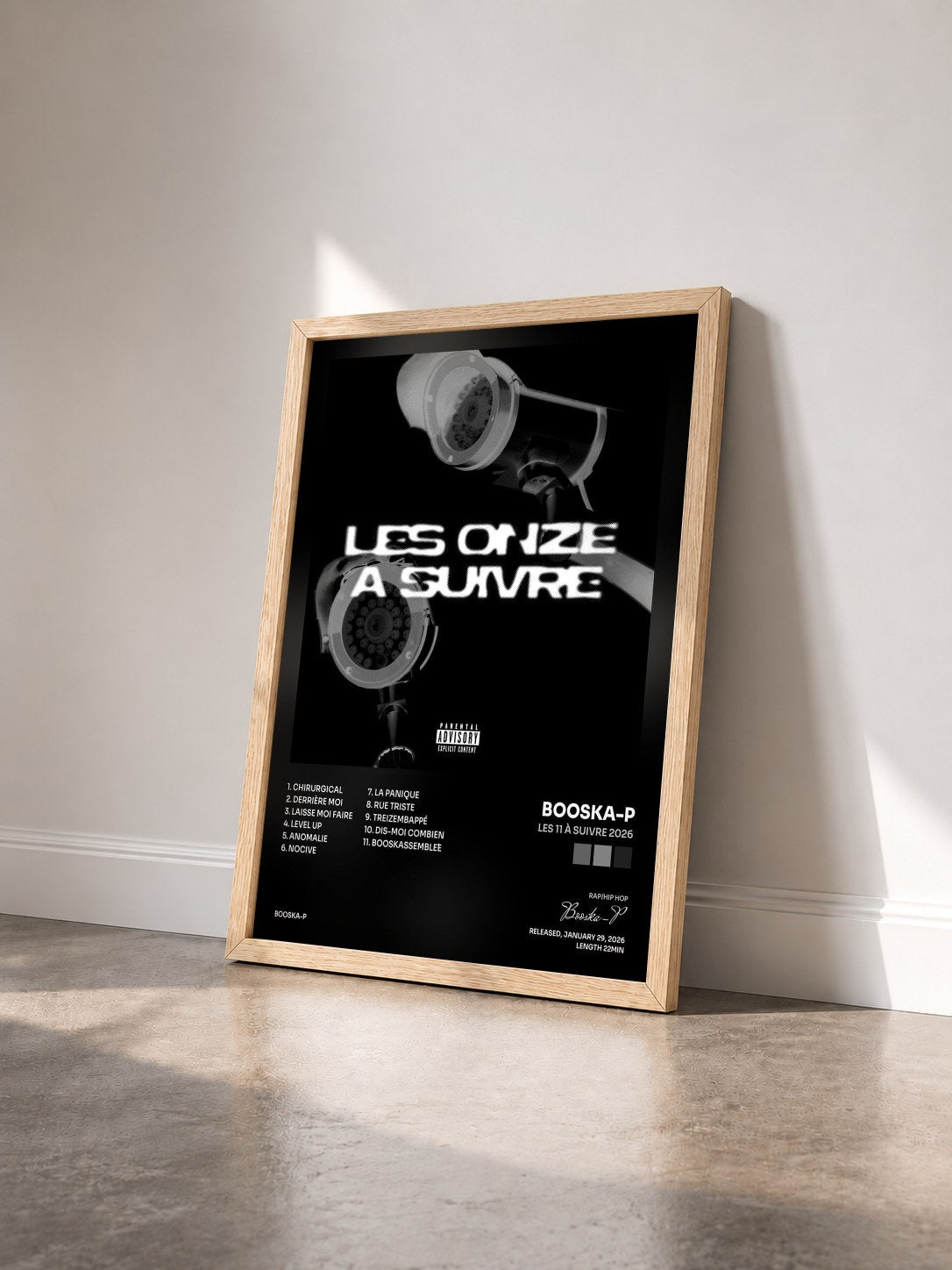 #bois Tableau de l'album Les 11 à suivre 2026 de Booska-P vu de trois quarts, cadre en bois brut