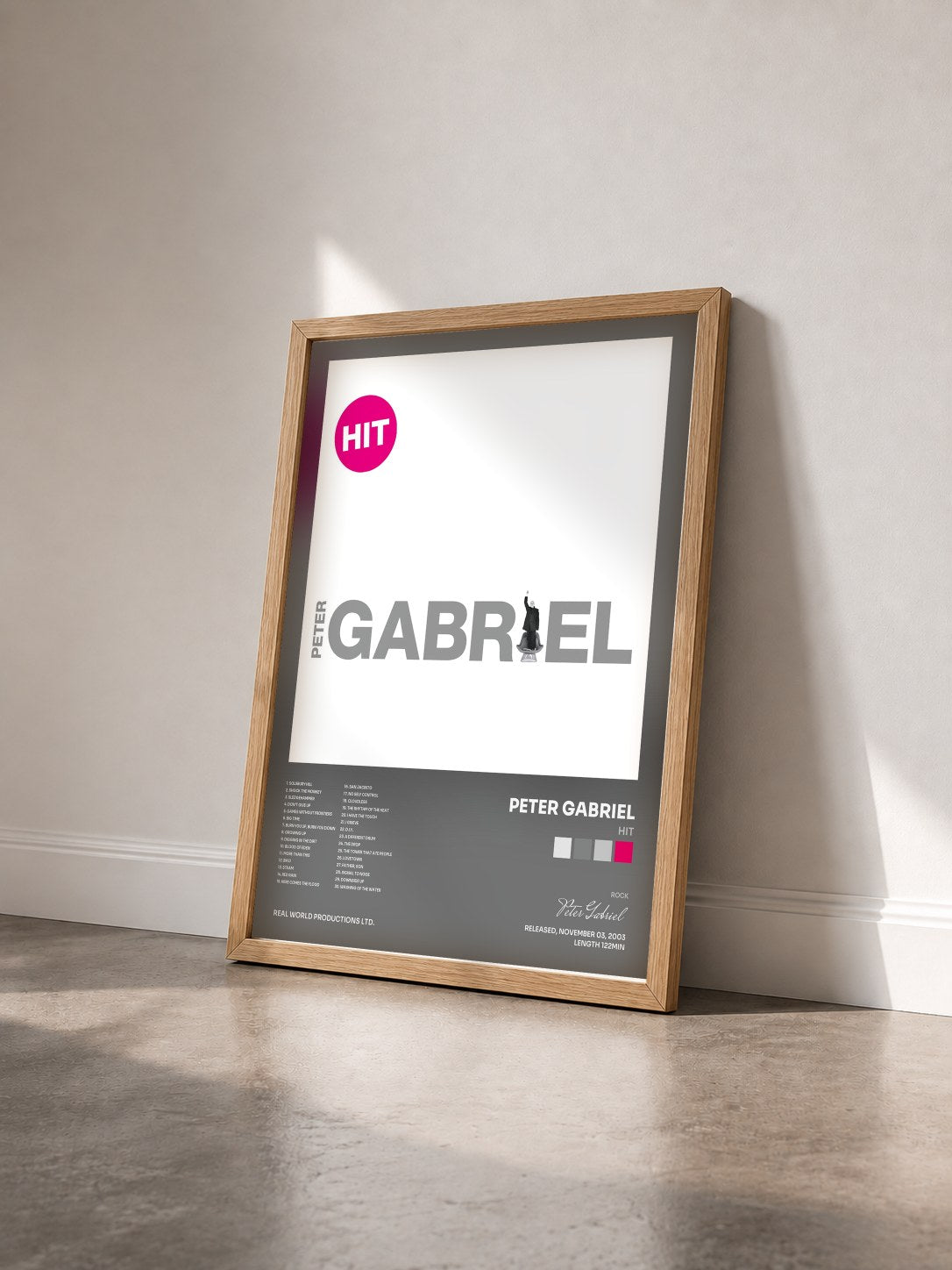 #bois Tableau de l'album Hit de Peter Gabriel vu de trois quarts, cadre en bois brut