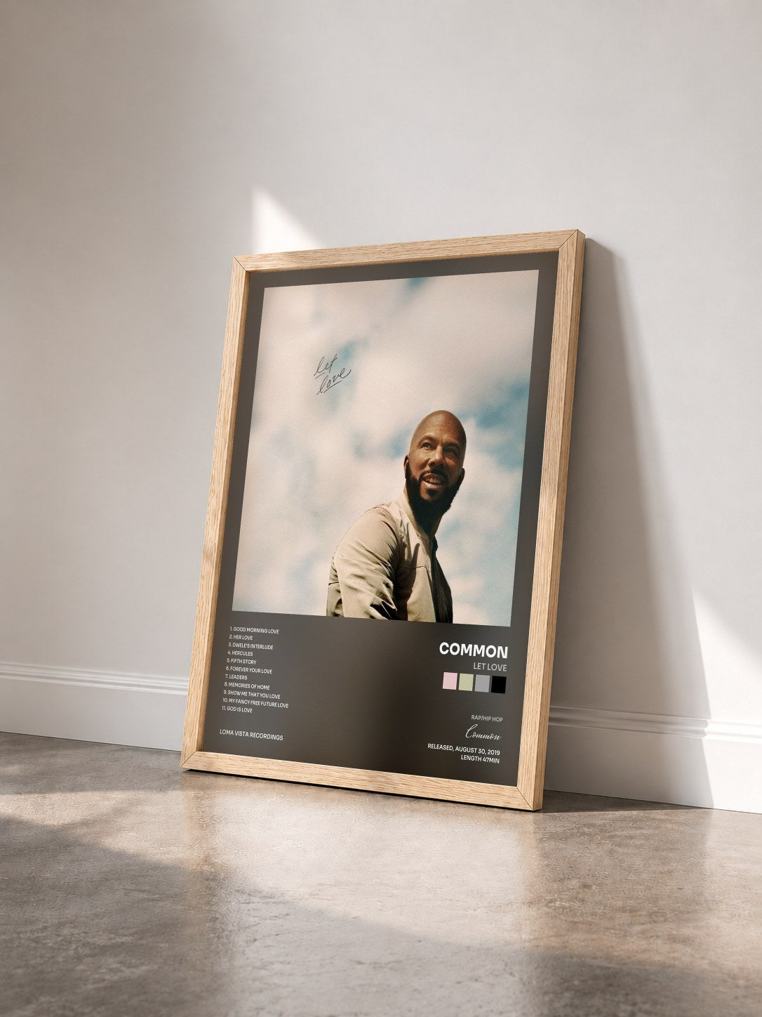 #bois Tableau de l'album Let Love de Common vu de trois quarts, cadre en bois brut