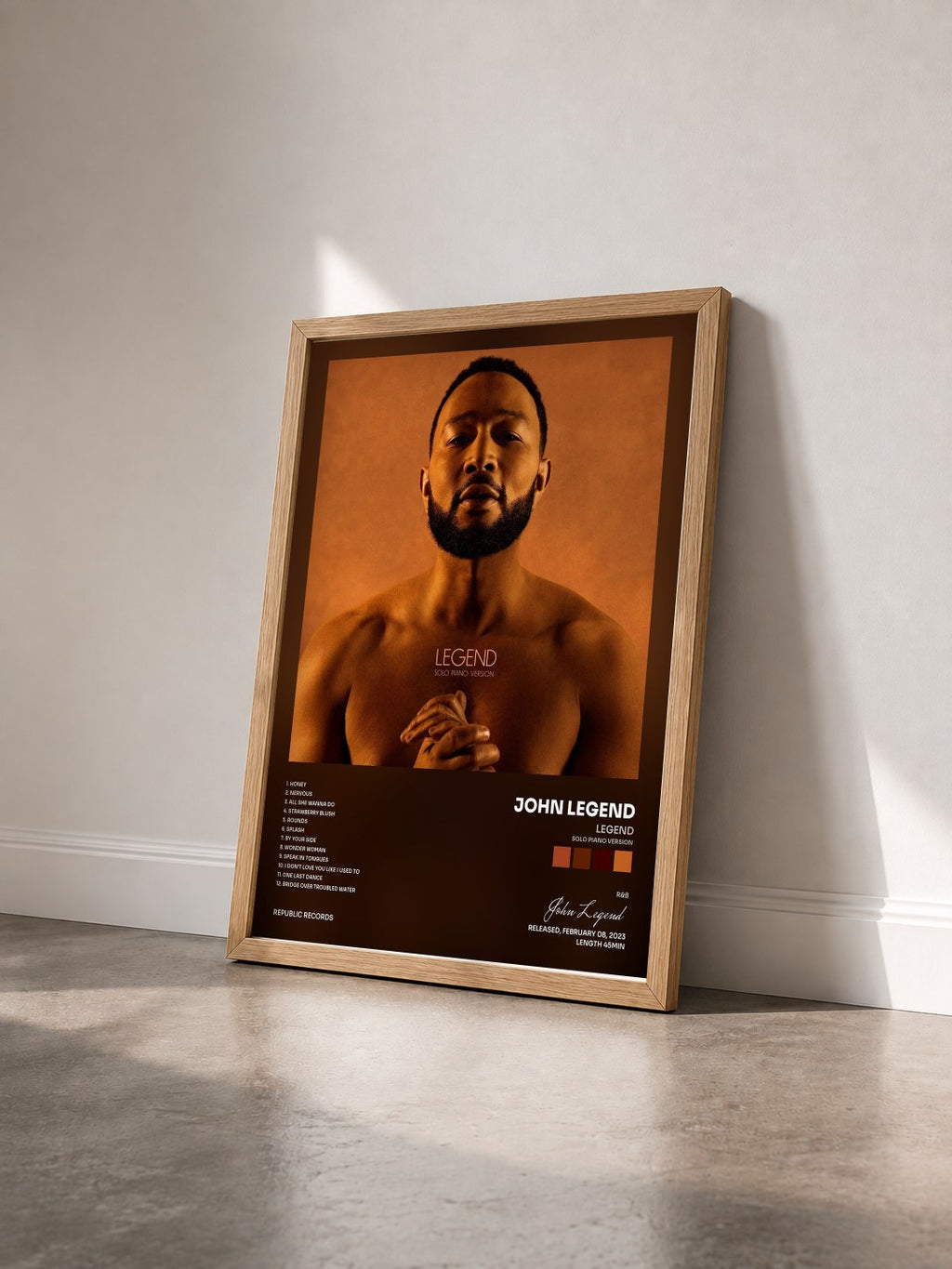 #bois Tableau de l'album LEGEND (Solo Piano Version) de John Legend vu de trois quarts, cadre en bois brut