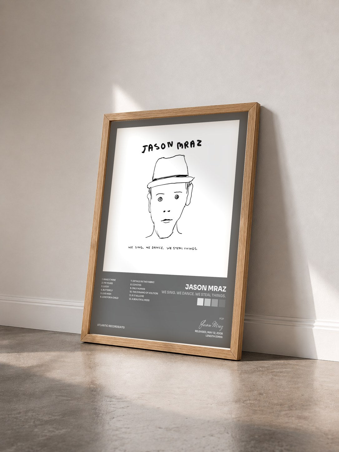 #bois Tableau de l'album We Sing. We Dance. We Steal Things. de Jason Mraz vu de trois quarts, cadre en bois brut
