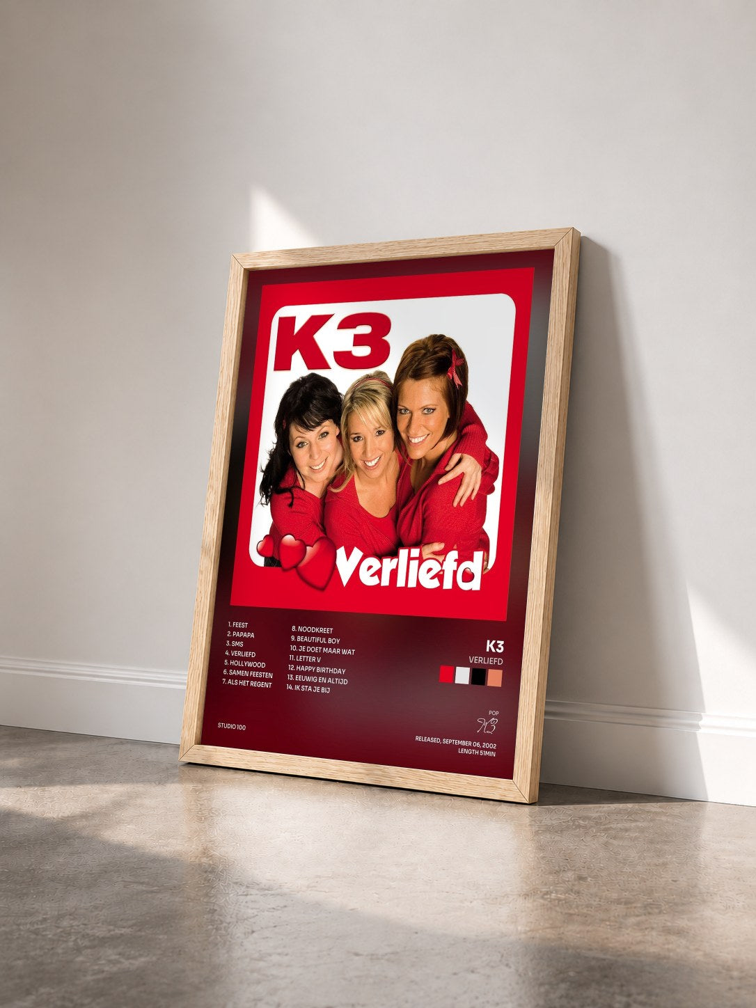 #bois Tableau de l'album Verliefd de K3 vu de trois quarts, cadre en bois brut