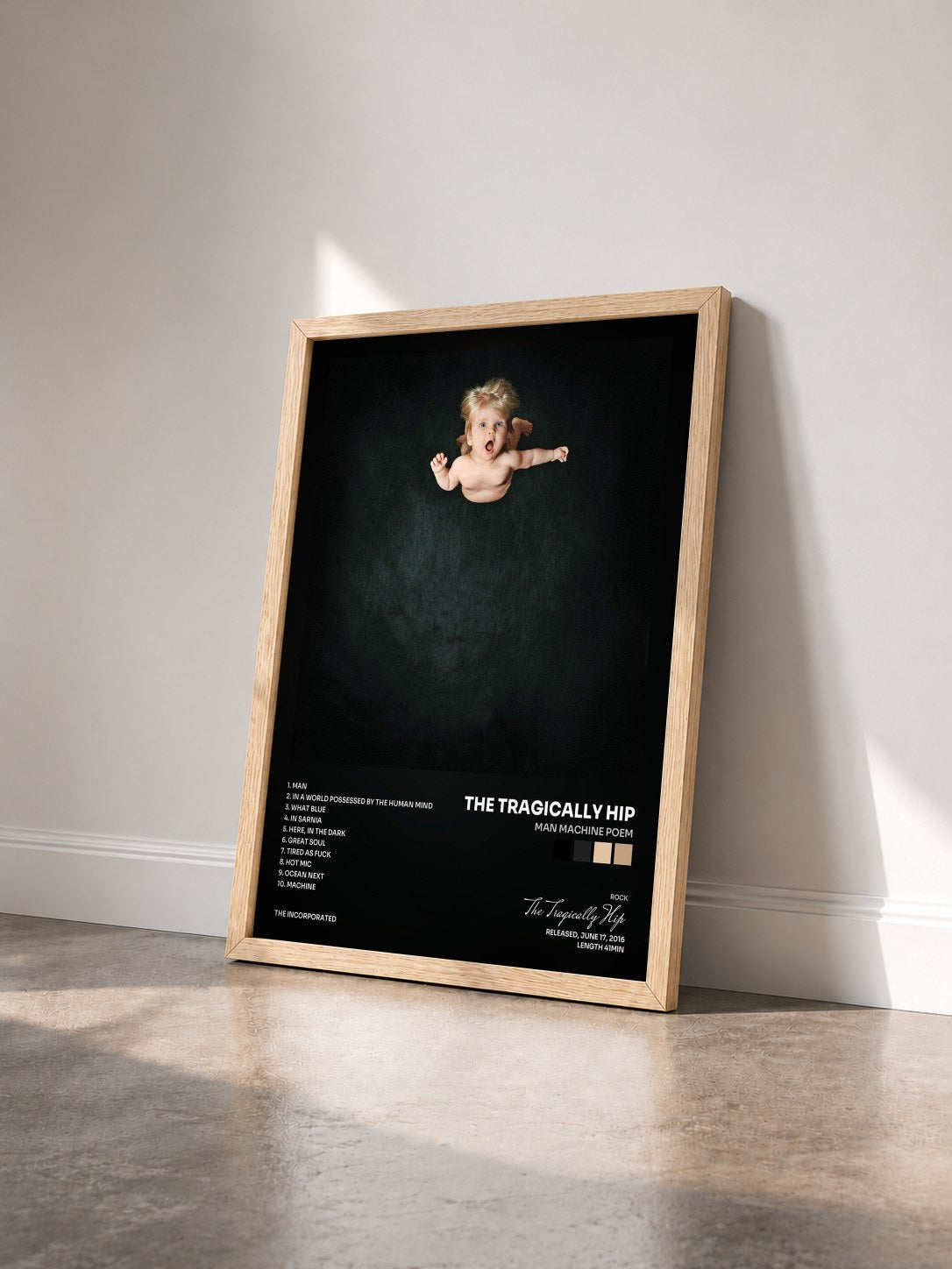 #bois Tableau de l'album Man Machine Poem de The Tragically Hip vu de trois quarts, cadre en bois brut