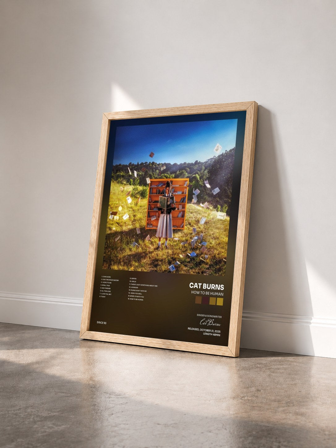 #bois Tableau de l'album How To Be Human de Cat Burns vu de trois quarts, cadre en bois brut