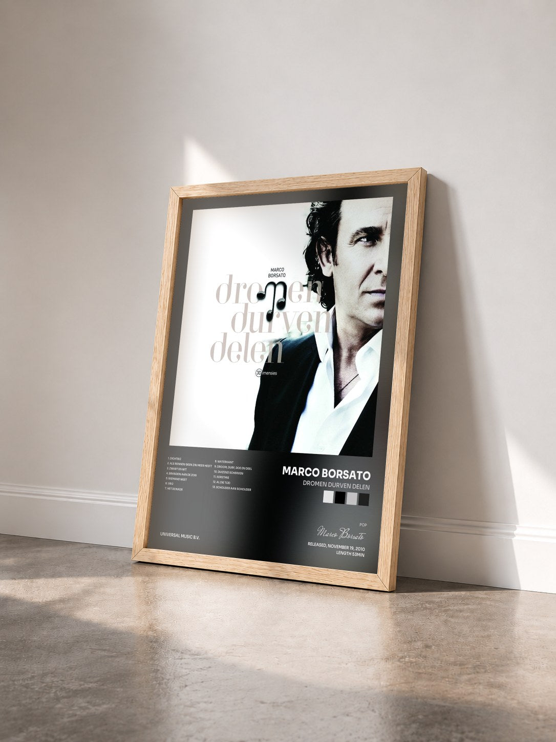 #bois Tableau de l'album Dromen Durven Delen de Marco Borsato vu de trois quarts, cadre en bois brut