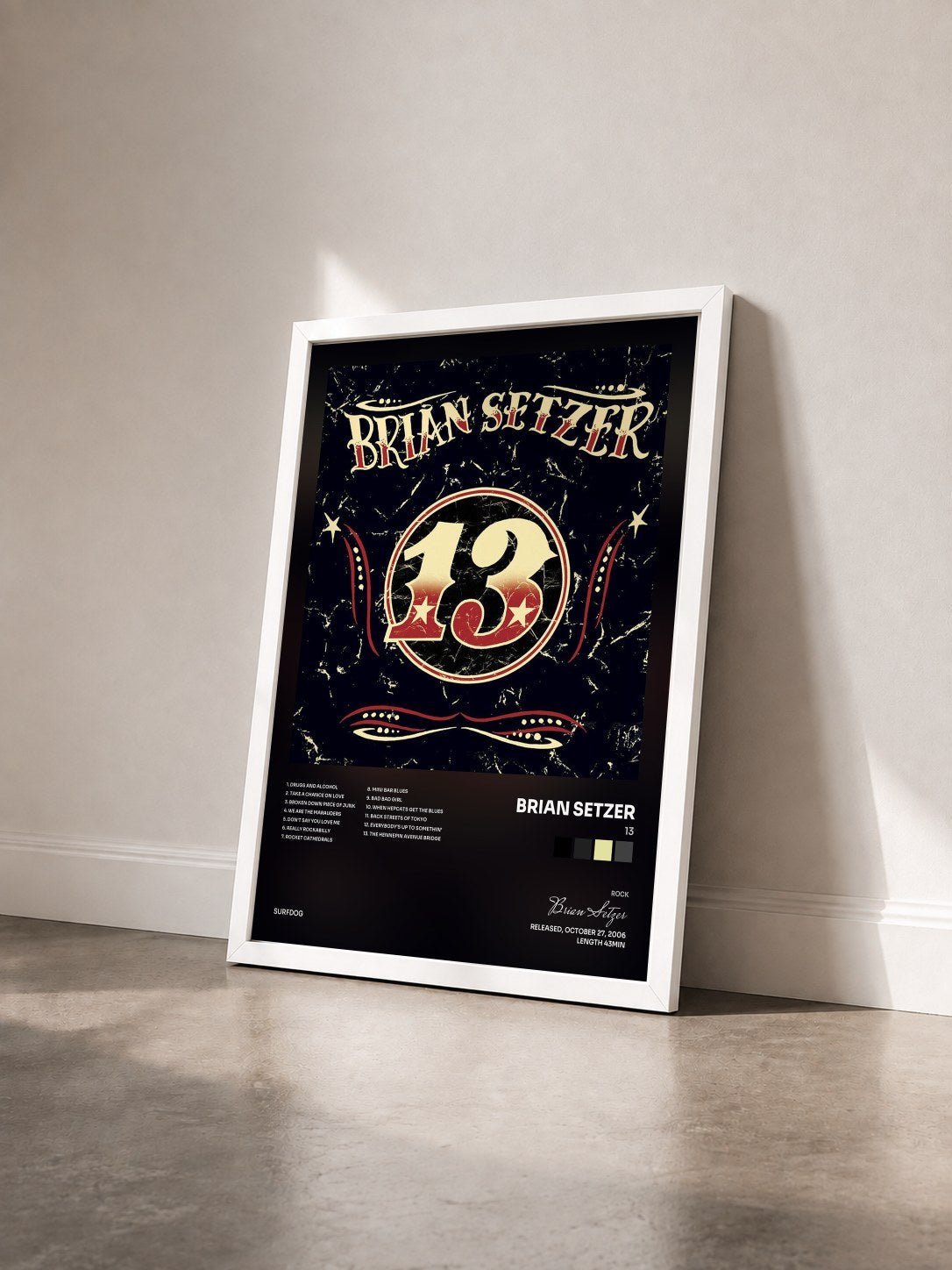 #blanc Tableau de l'album 13 de Brian Setzer vu de trois quarts, cadre blanc