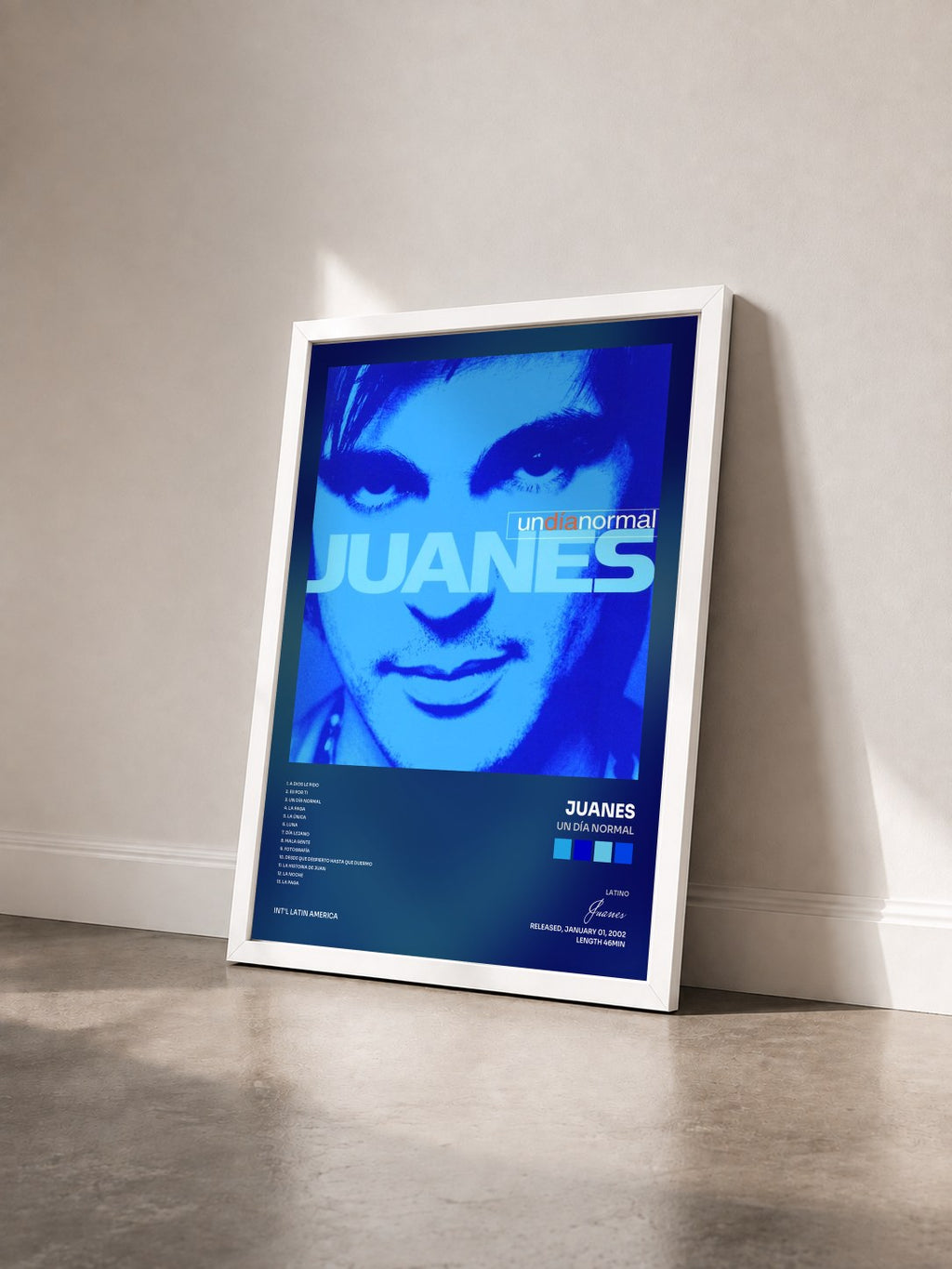 #blanc Tableau de l'album Un Día Normal de Juanes vu de trois quarts, cadre blanc