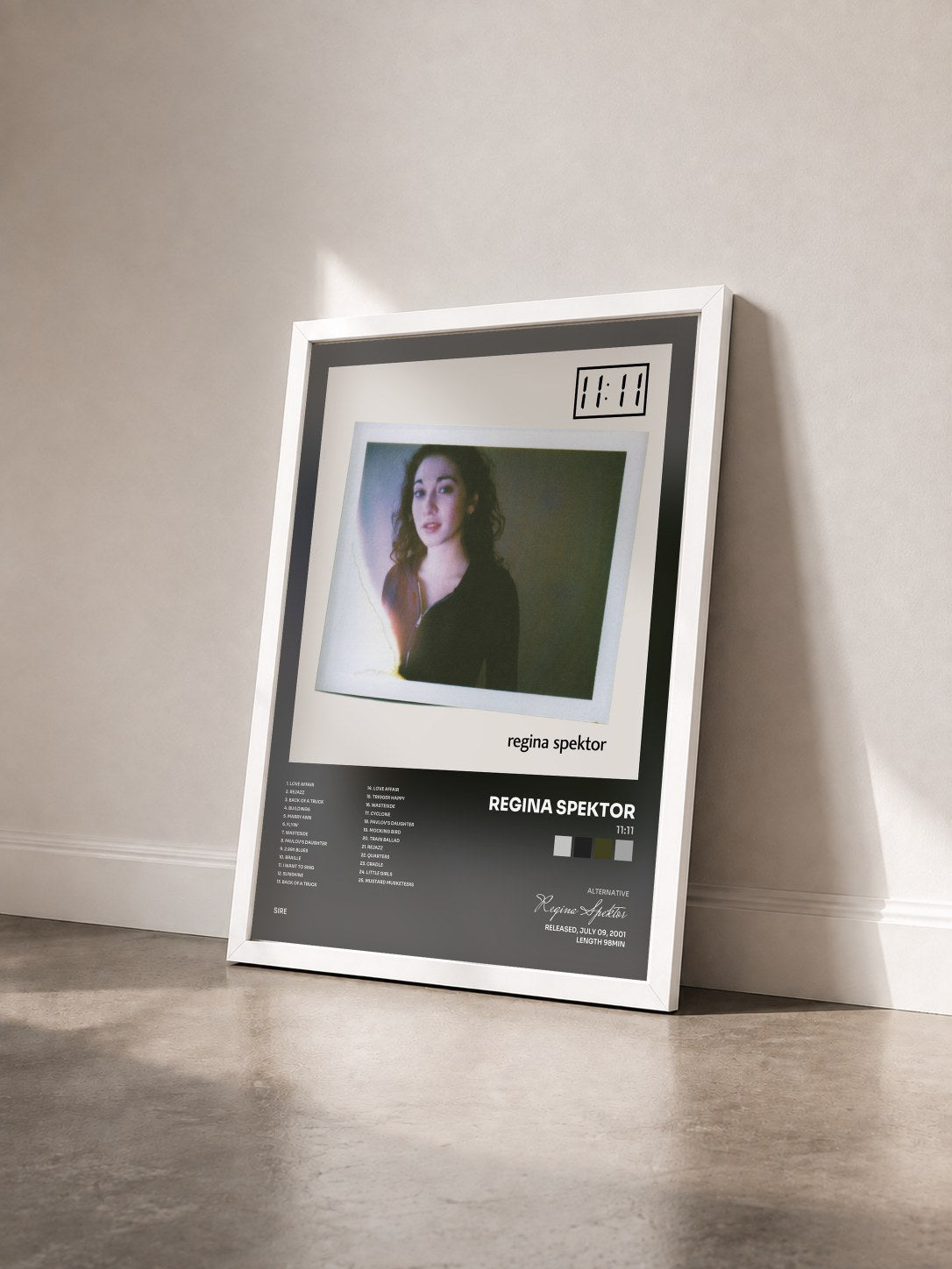 #blanc Tableau de l'album 11:11 de Regina Spektor vu de trois quarts, cadre blanc