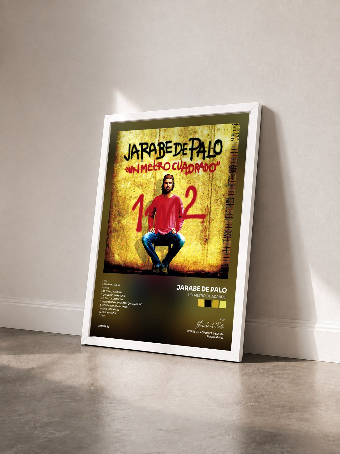 #blanc Tableau de l'album Un metro cuadrado de Jarabe de Palo vu de trois quarts, cadre blanc