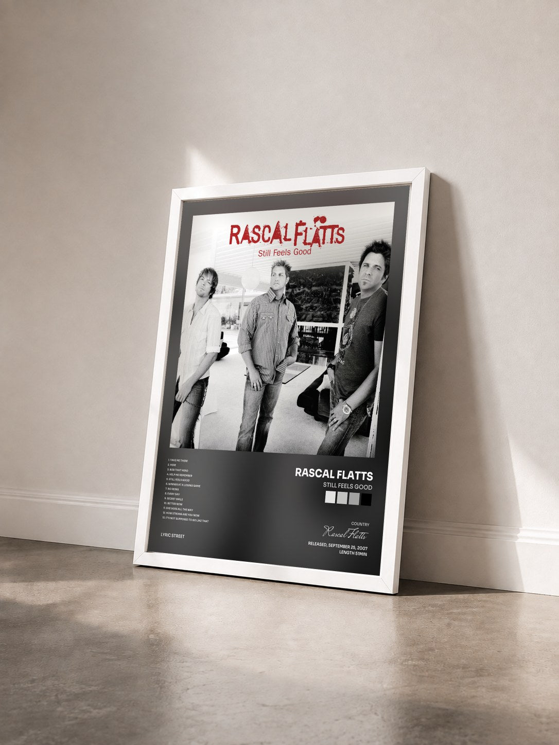 #blanc Tableau de l'album Still Feels Good de Rascal Flatts vu de trois quarts, cadre blanc