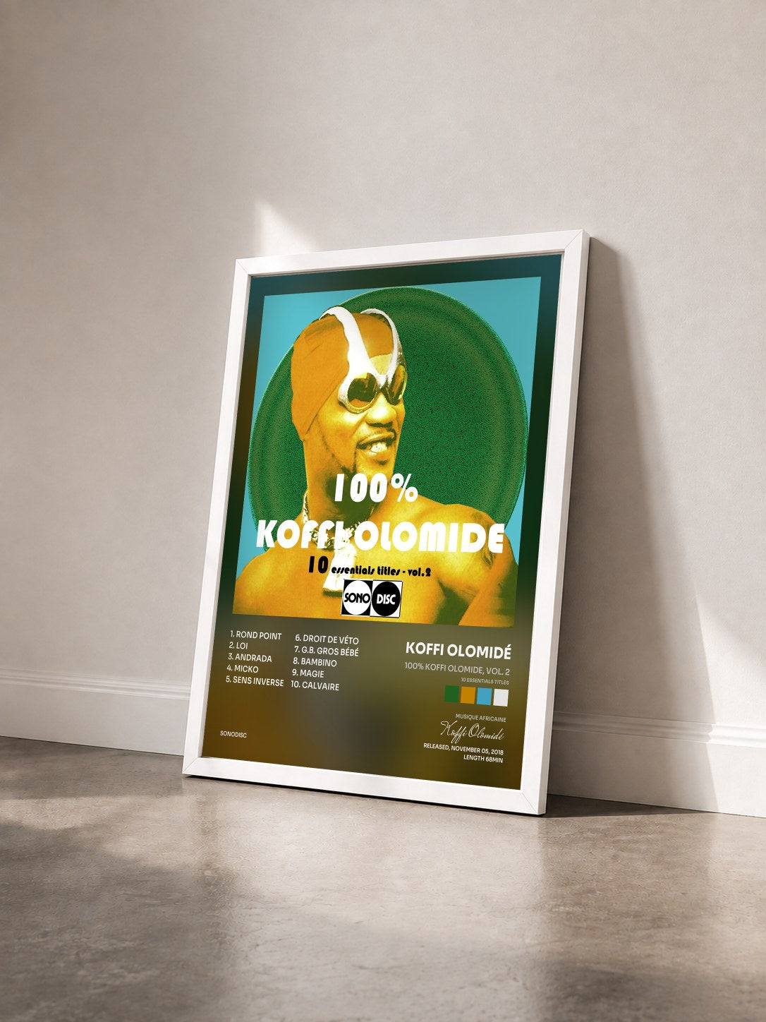 #blanc Tableau de l'album 100% Koffi Olomide, vol. 2 (10 Essentials Titles) de Koffi Olomidé vu de trois quarts, cadre blanc