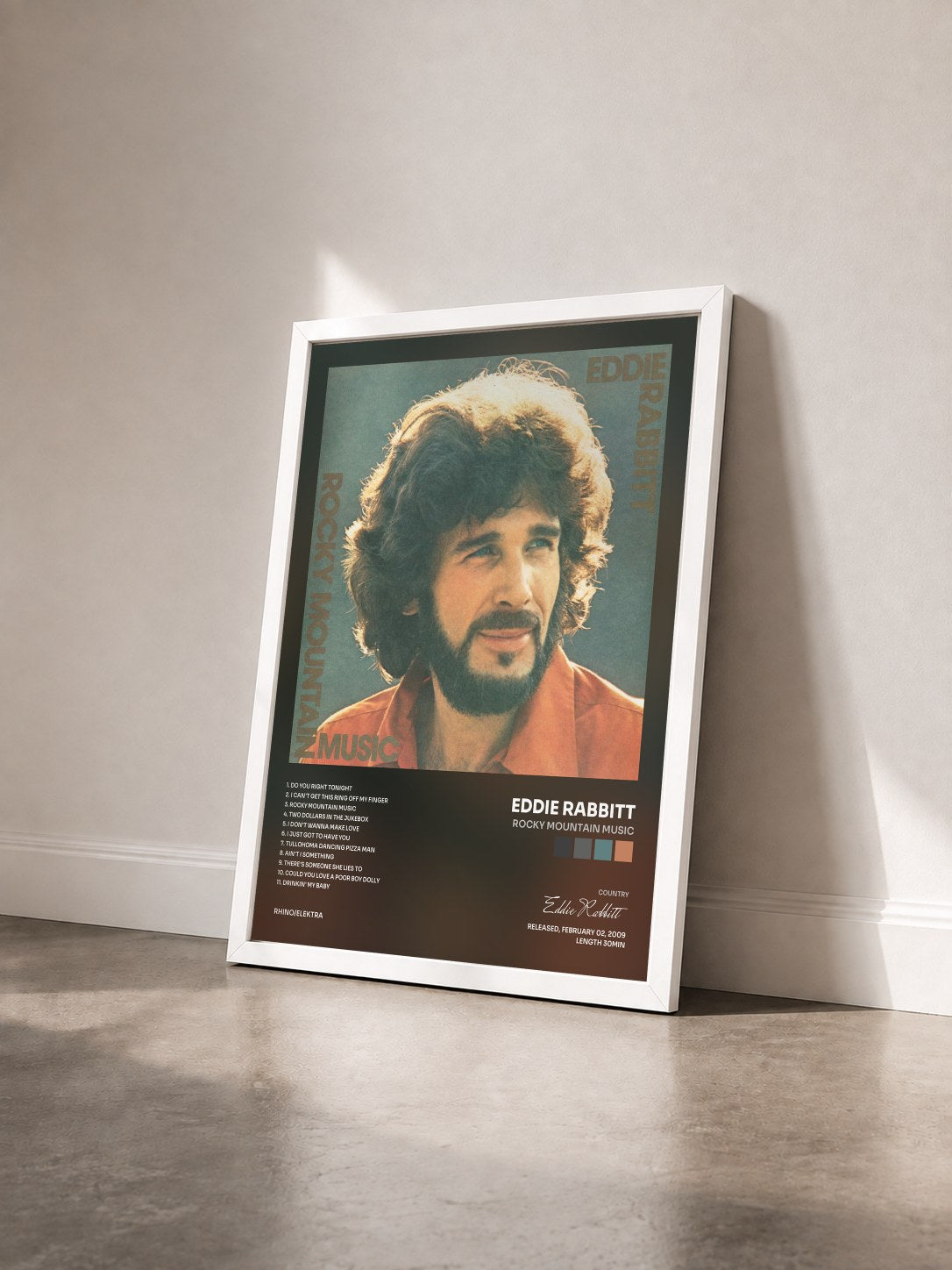 #blanc Tableau de l'album Rocky Mountain Music de Eddie Rabbitt vu de trois quarts, cadre blanc