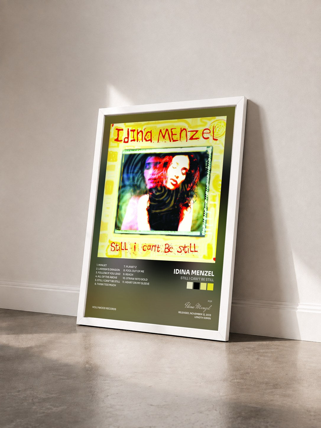 #blanc Tableau de l'album Still I Can't Be Still de Idina Menzel vu de trois quarts, cadre blanc