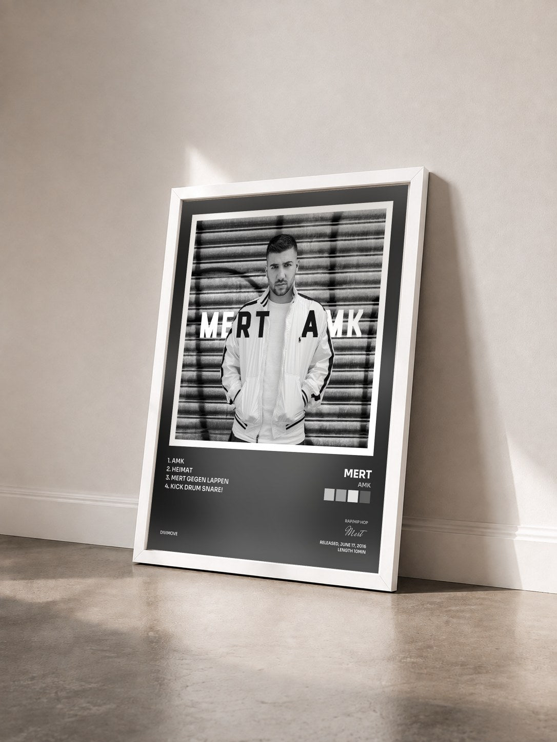 #blanc Tableau de l'album AMK de Mert vu de trois quarts, cadre blanc