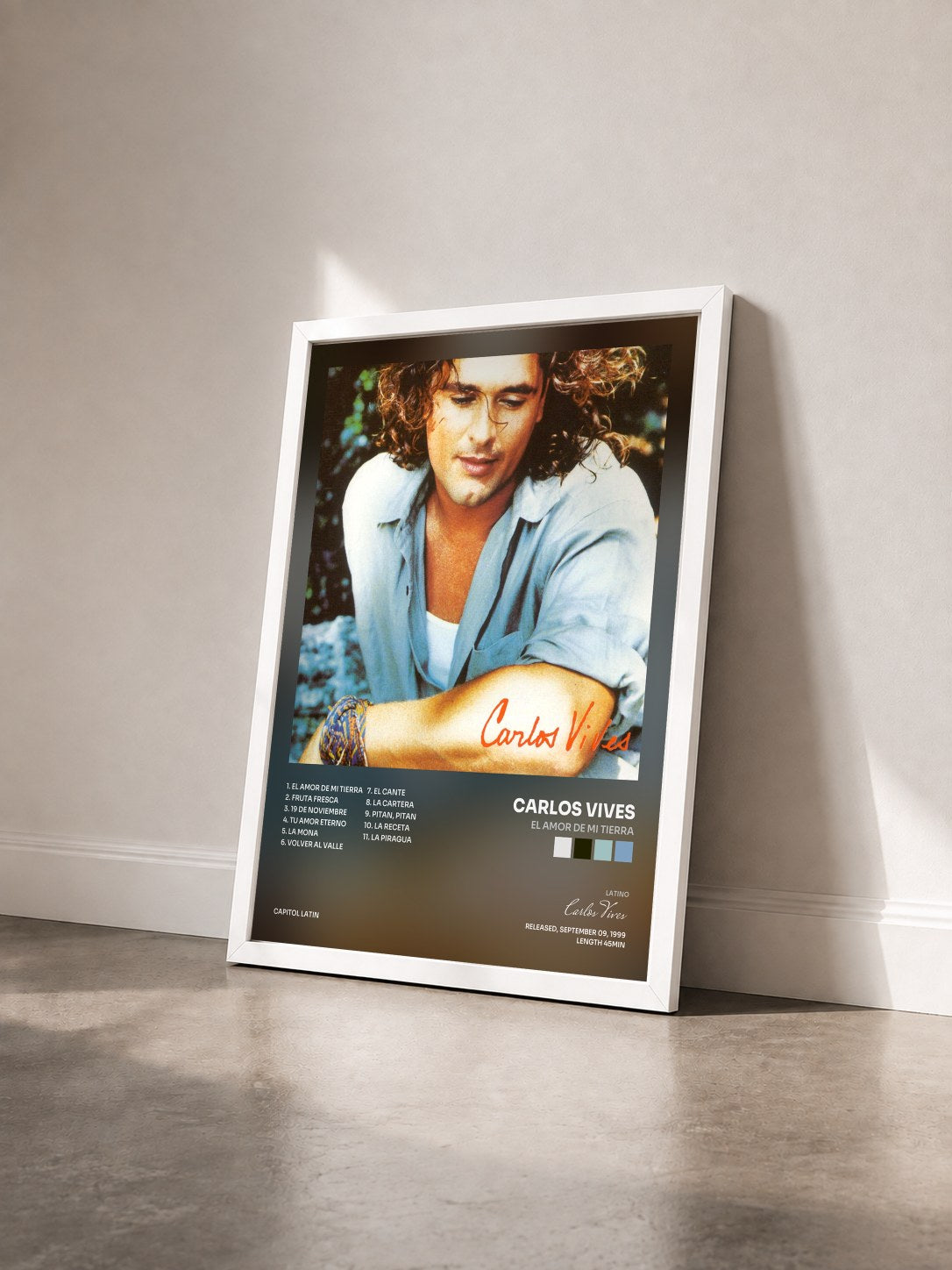 #blanc Tableau de l'album El Amor De Mi Tierra de Carlos Vives vu de trois quarts, cadre blanc