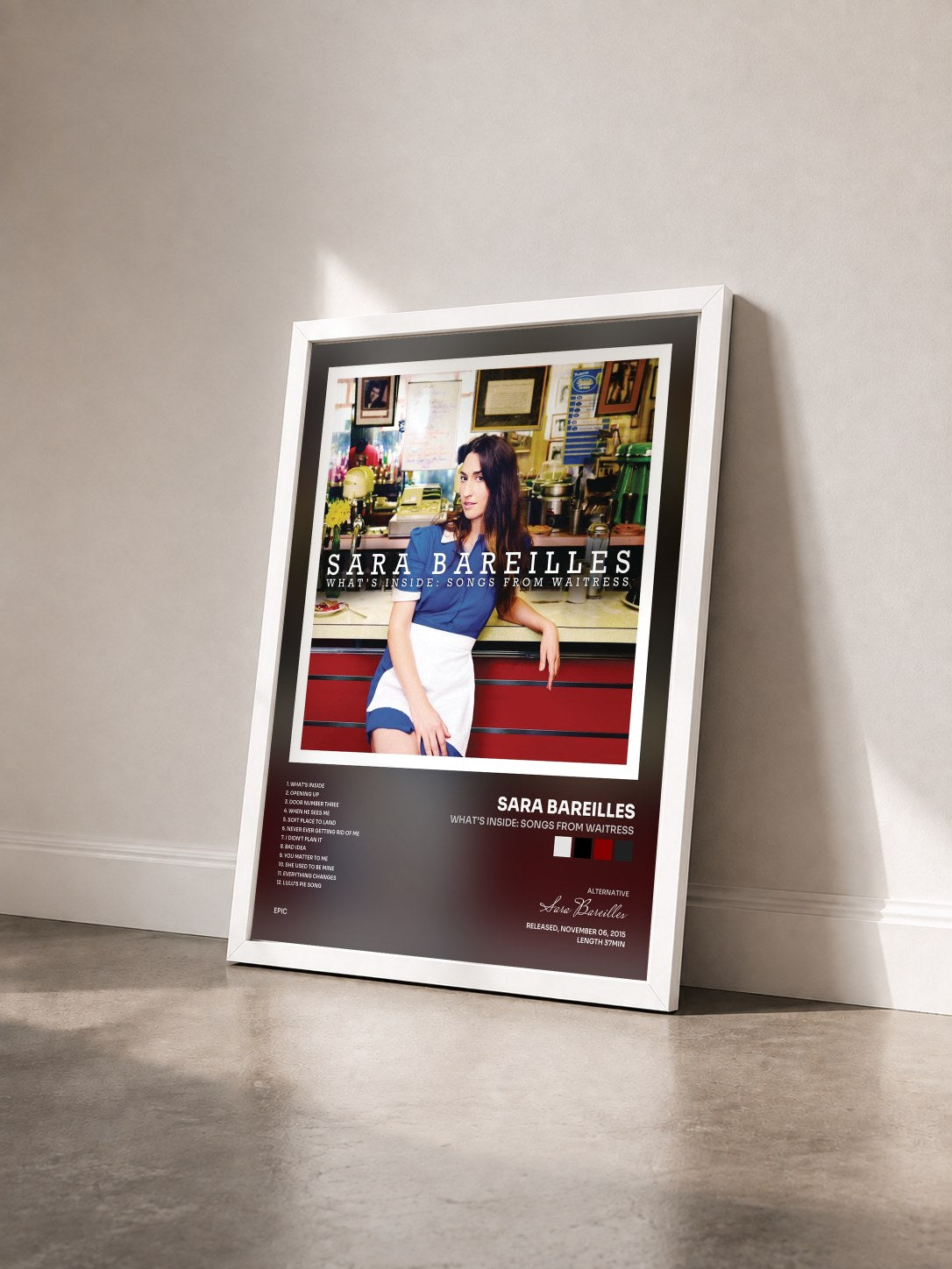#blanc Tableau de l'album What's Inside: Songs from Waitress de Sara Bareilles vu de trois quarts, cadre blanc