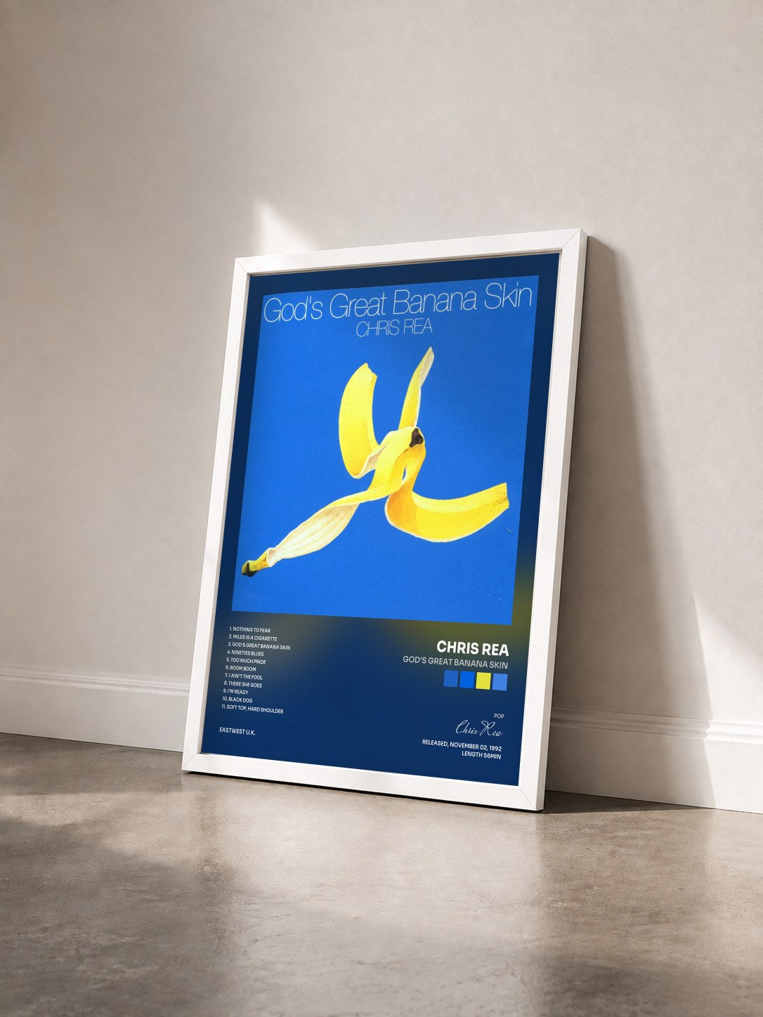 #blanc Tableau de l'album God's Great Banana Skin de Chris Rea vu de trois quarts, cadre blanc