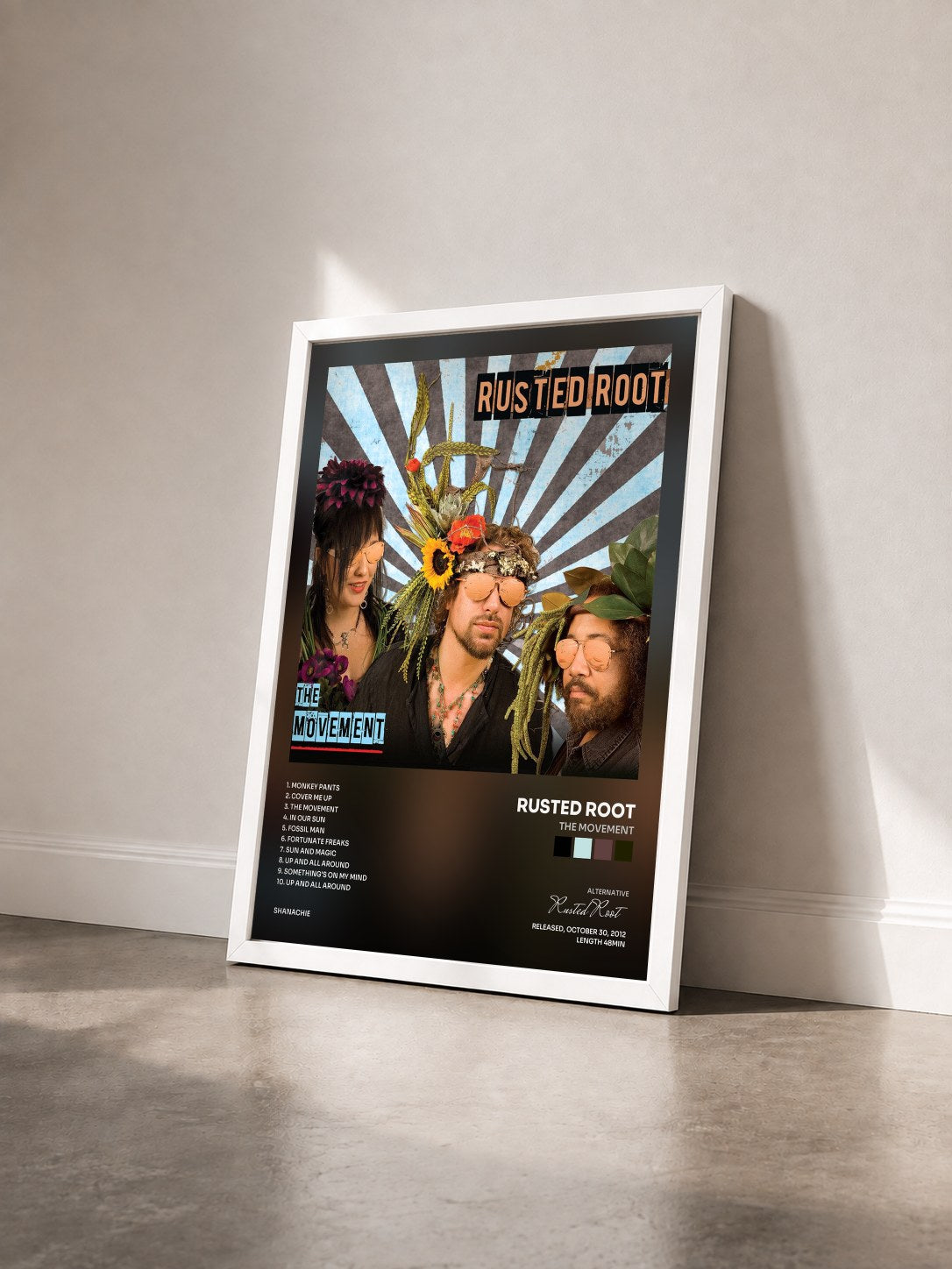 #blanc Tableau de l'album The Movement de Rusted Root vu de trois quarts, cadre blanc
