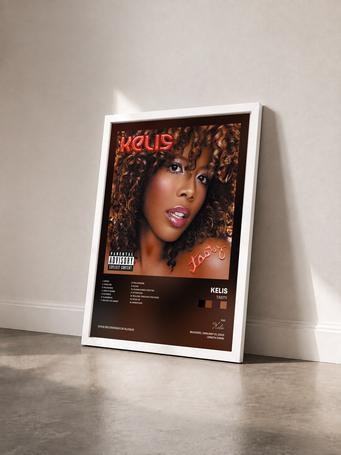 #blanc Tableau de l'album Tasty de Kelis vu de trois quarts, cadre blanc