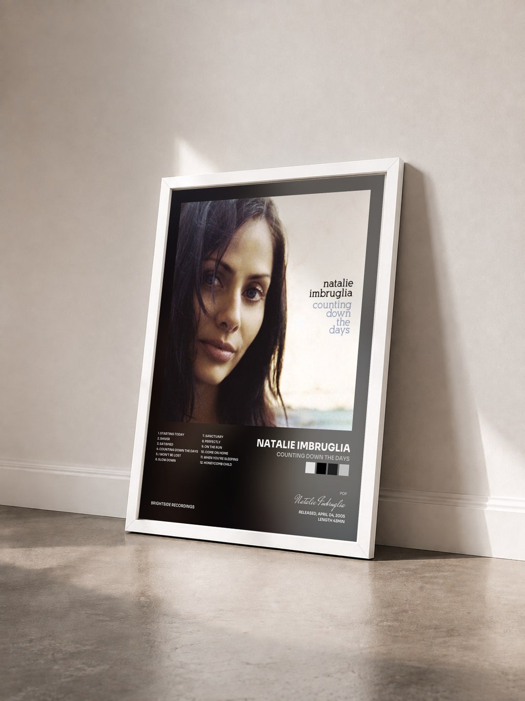 #blanc Counting Down The Days by Natalie Imbruglia as a framed art print seen at an angle, white frame