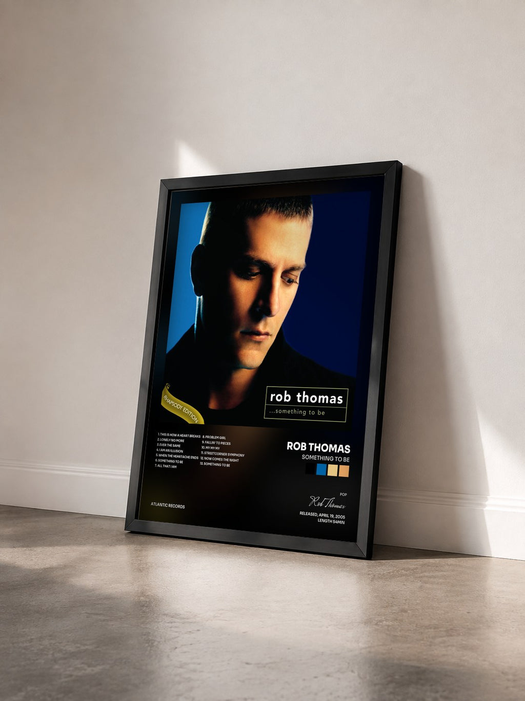 #noir Tableau de l'album Something to Be de Rob Thomas vu de trois quarts, cadre noir