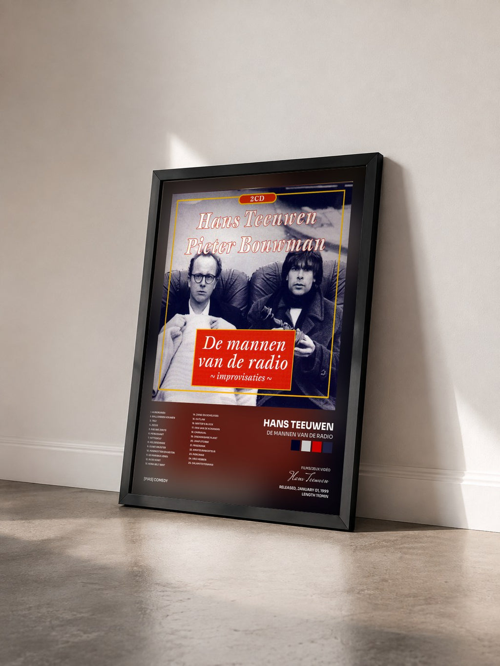 #noir Tableau de l'album De Mannen Van De Radio de Hans Teeuwen vu de trois quarts, cadre noir