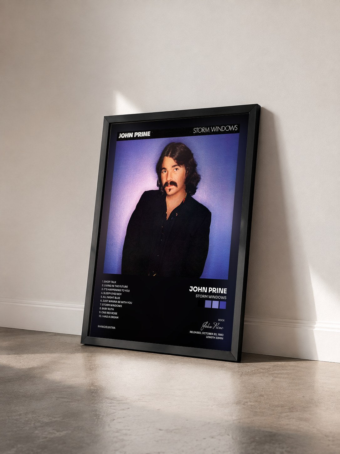 #noir Tableau de l'album Storm Windows de John Prine vu de trois quarts, cadre noir