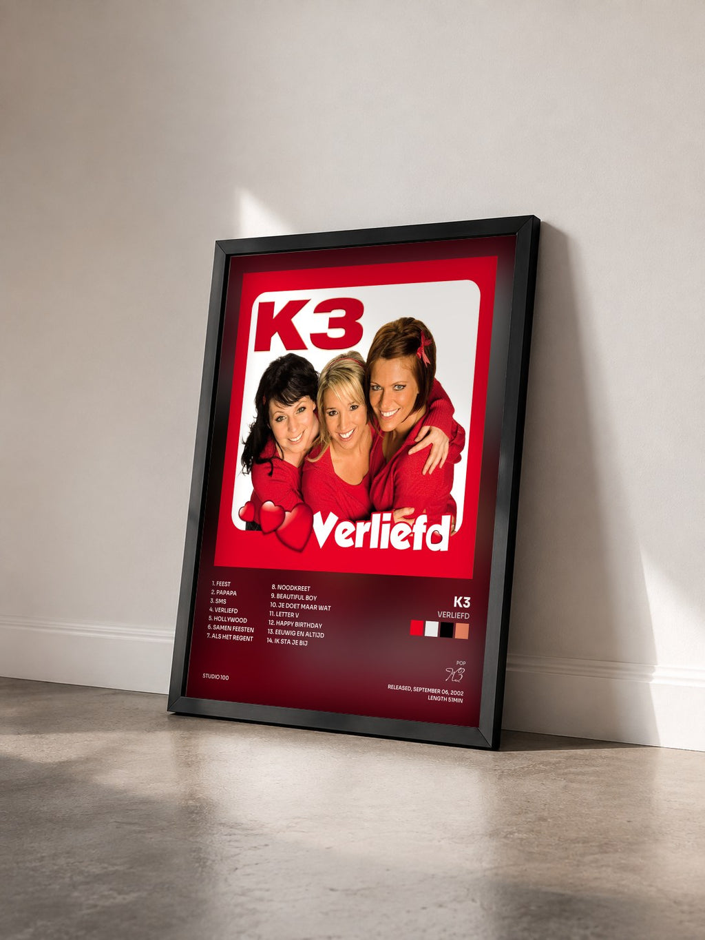 #noir Tableau de l'album Verliefd de K3 vu de trois quarts, cadre noir