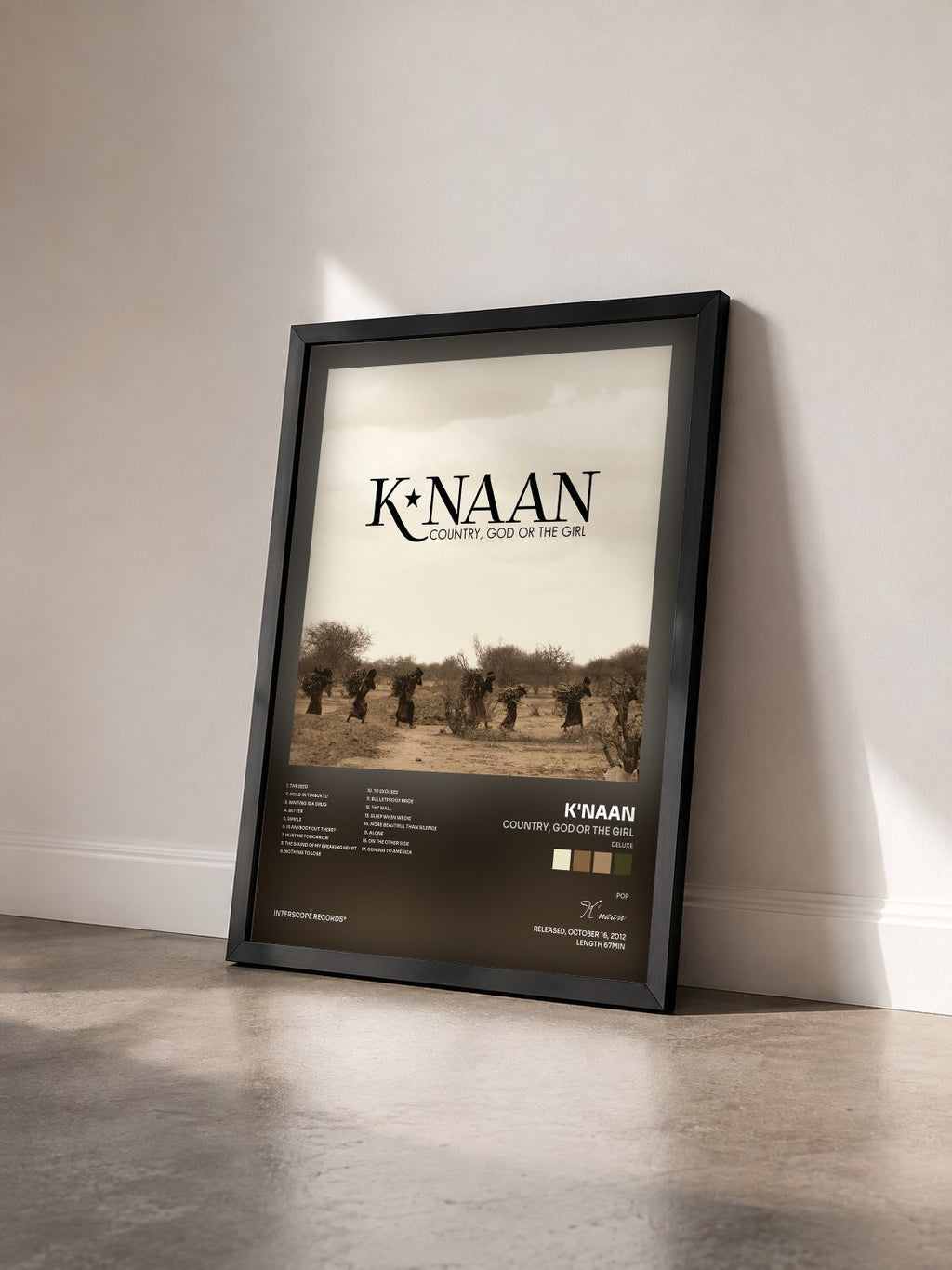 #noir Tableau de l'album Country, God Or The Girl (Deluxe) de K'naan vu de trois quarts, cadre noir