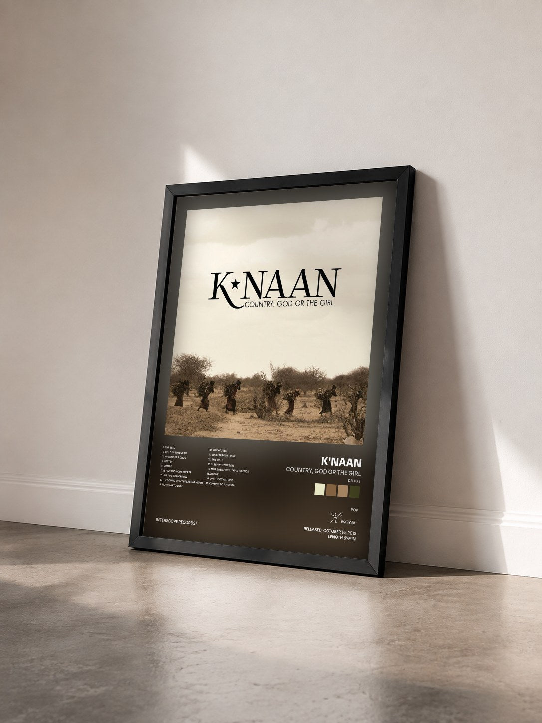 #noir Tableau de l'album Country, God Or The Girl (Deluxe) de K'naan vu de trois quarts, cadre noir