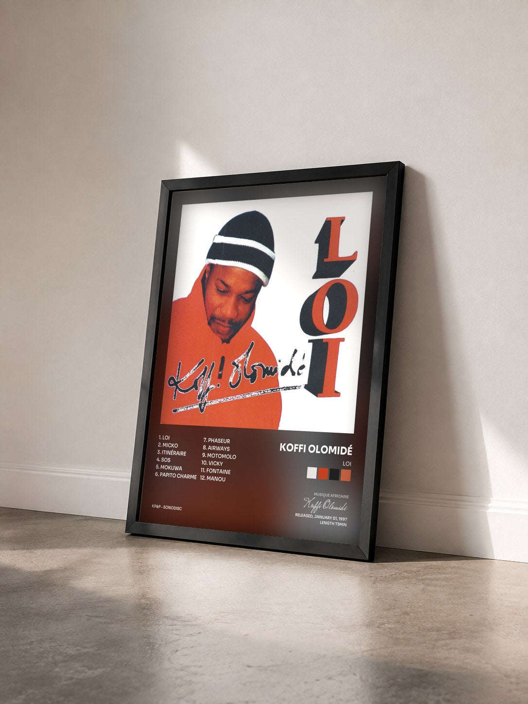 #noir Tableau de l'album Loi de Koffi Olomidé vu de trois quarts, cadre noir