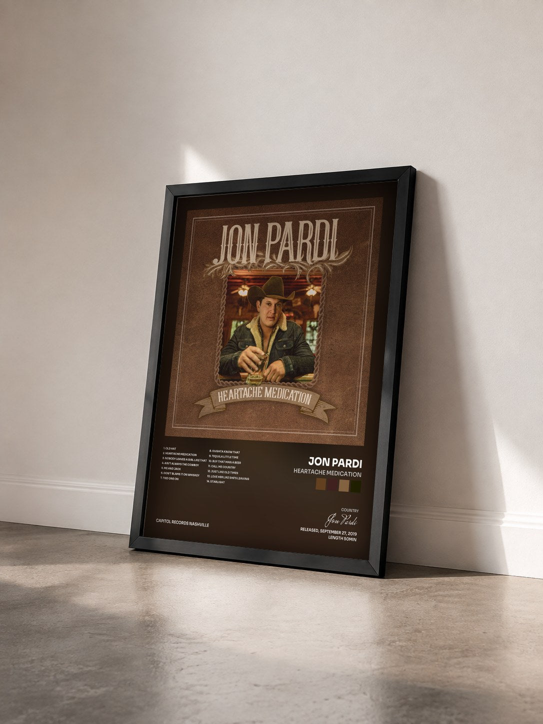 #noir Tableau de l'album Heartache Medication de Jon Pardi vu de trois quarts, cadre noir