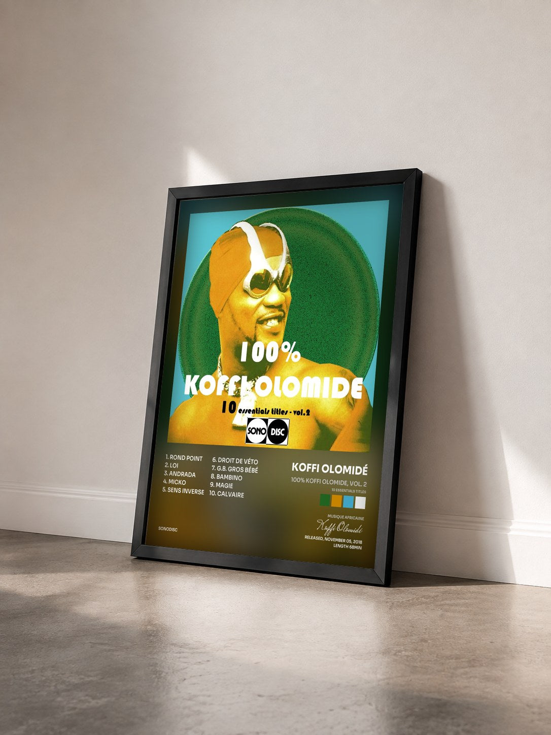 #noir Tableau de l'album 100% Koffi Olomide, vol. 2 (10 Essentials Titles) de Koffi Olomidé vu de trois quarts, cadre noir