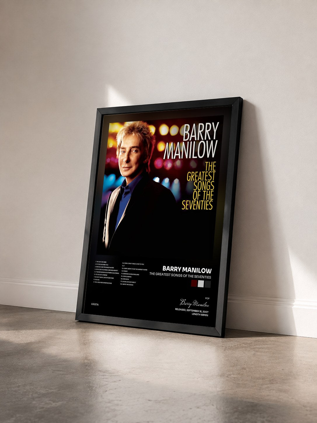 #noir Tableau de l'album The Greatest Songs Of The Seventies de Barry Manilow vu de trois quarts, cadre noir