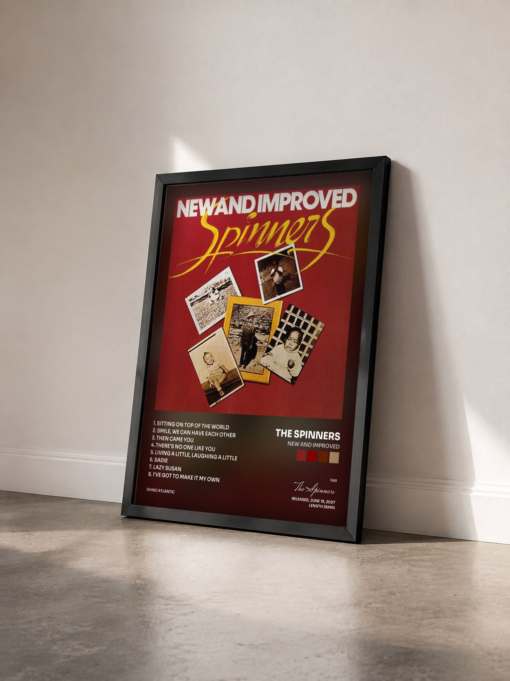 #noir Tableau de l'album New And Improved de The Spinners vu de trois quarts, cadre noir