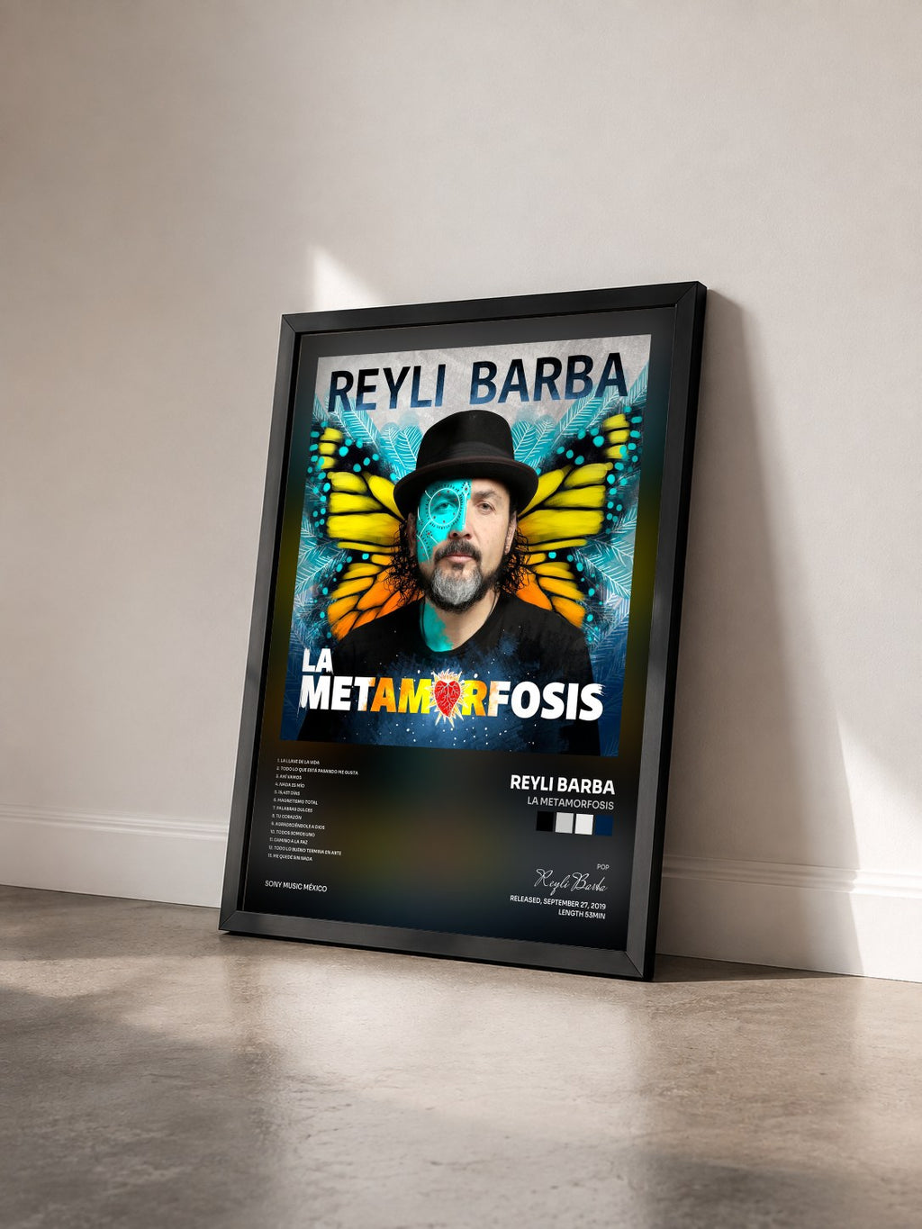 #noir Tableau de l'album La Metamorfosis de Reyli Barba vu de trois quarts, cadre noir