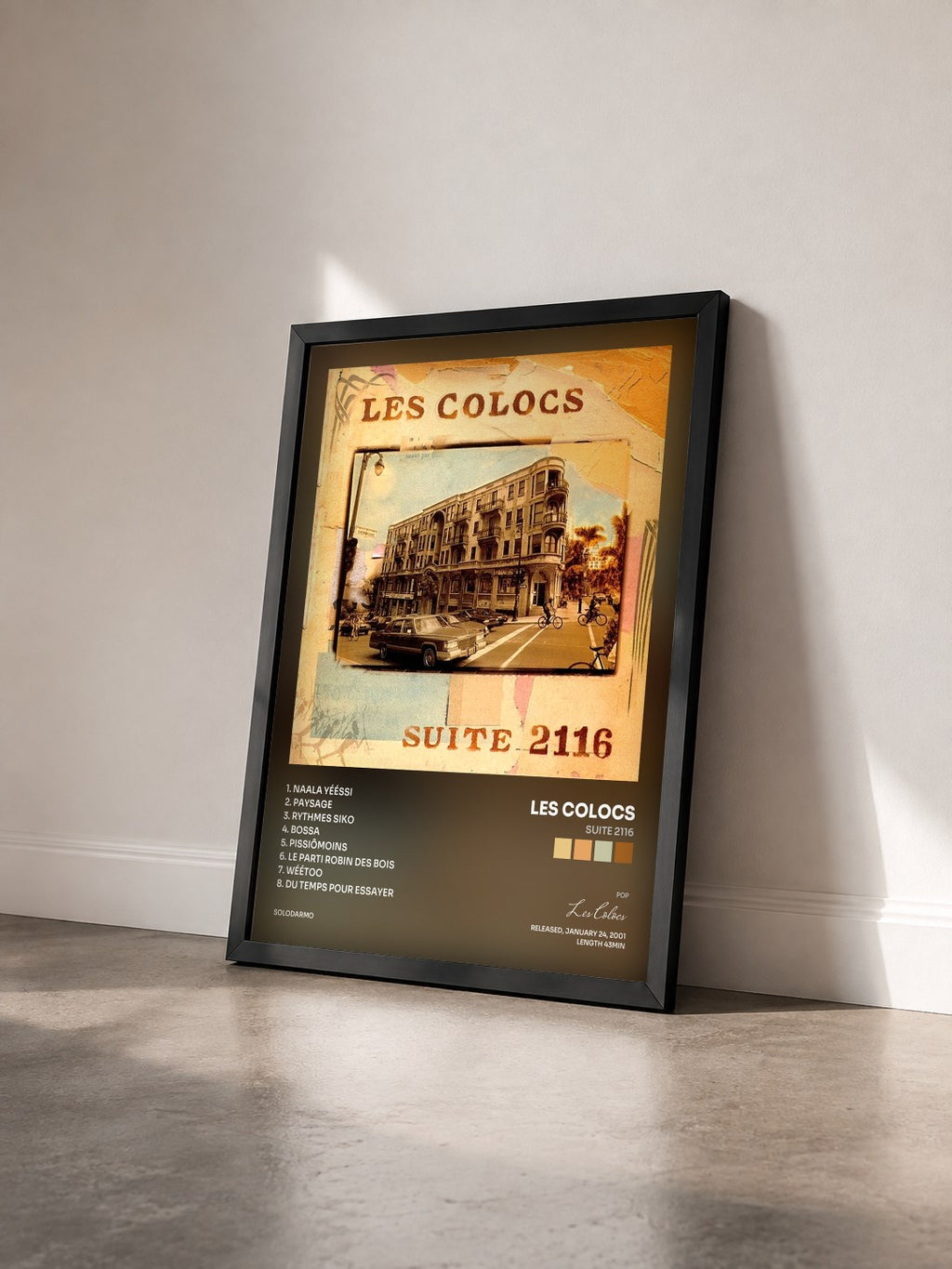 #noir Tableau de l'album Suite 2116 de Les Colocs vu de trois quarts, cadre noir