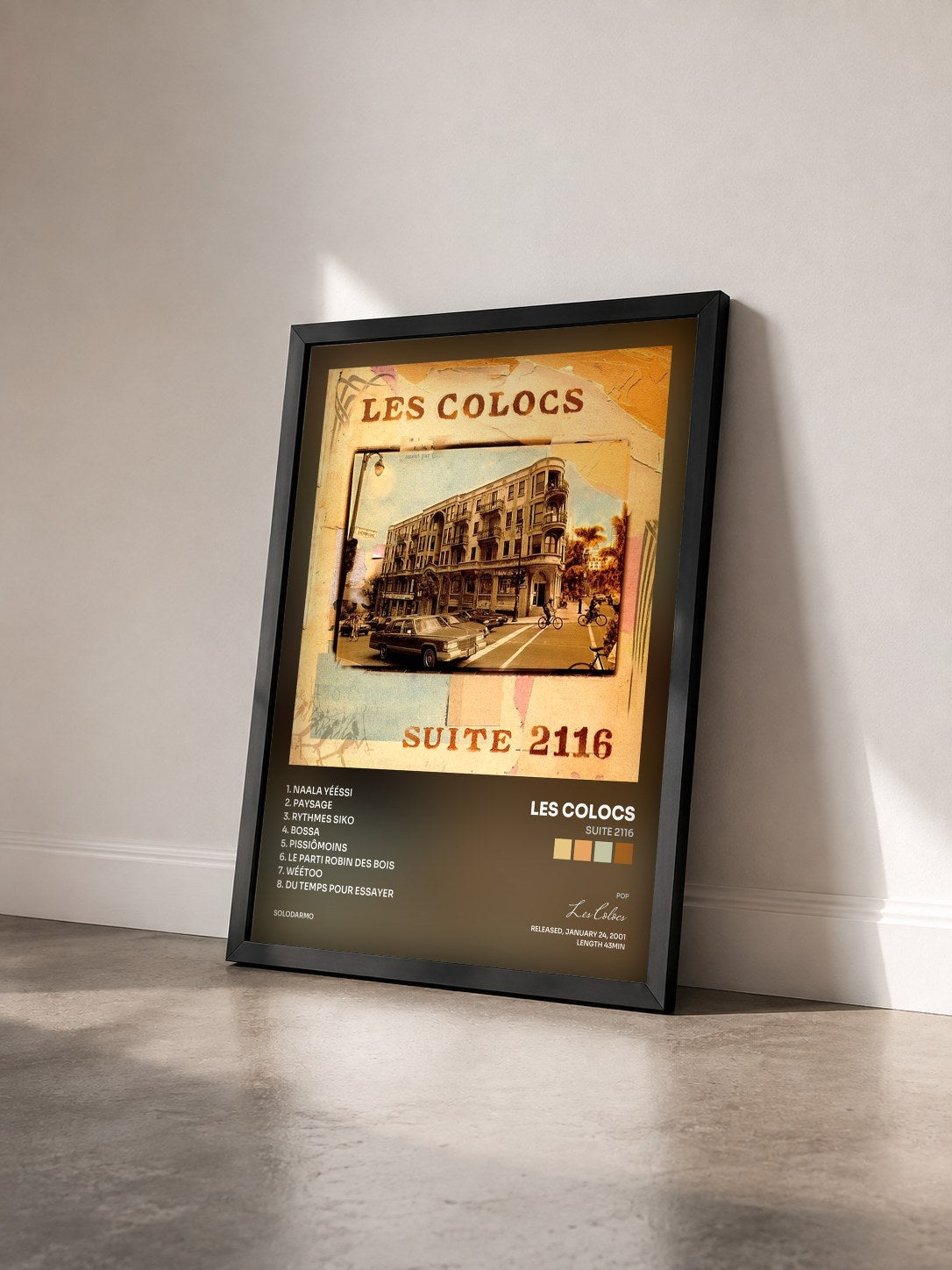 #noir Tableau de l'album Suite 2116 de Les Colocs vu de trois quarts, cadre noir