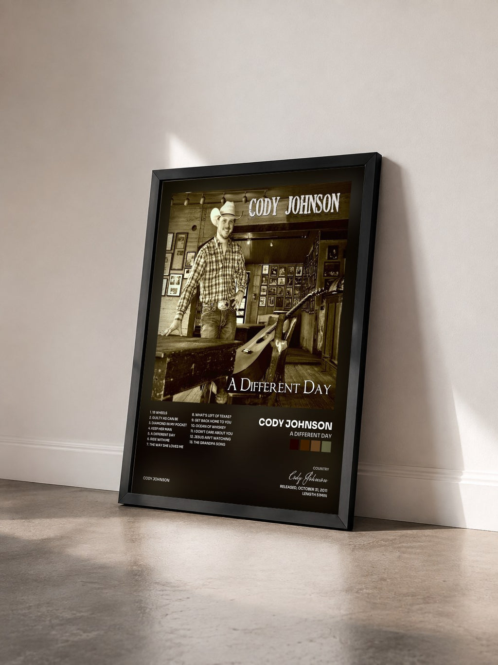 #noir Tableau de l'album A Different Day de Cody Johnson vu de trois quarts, cadre noir