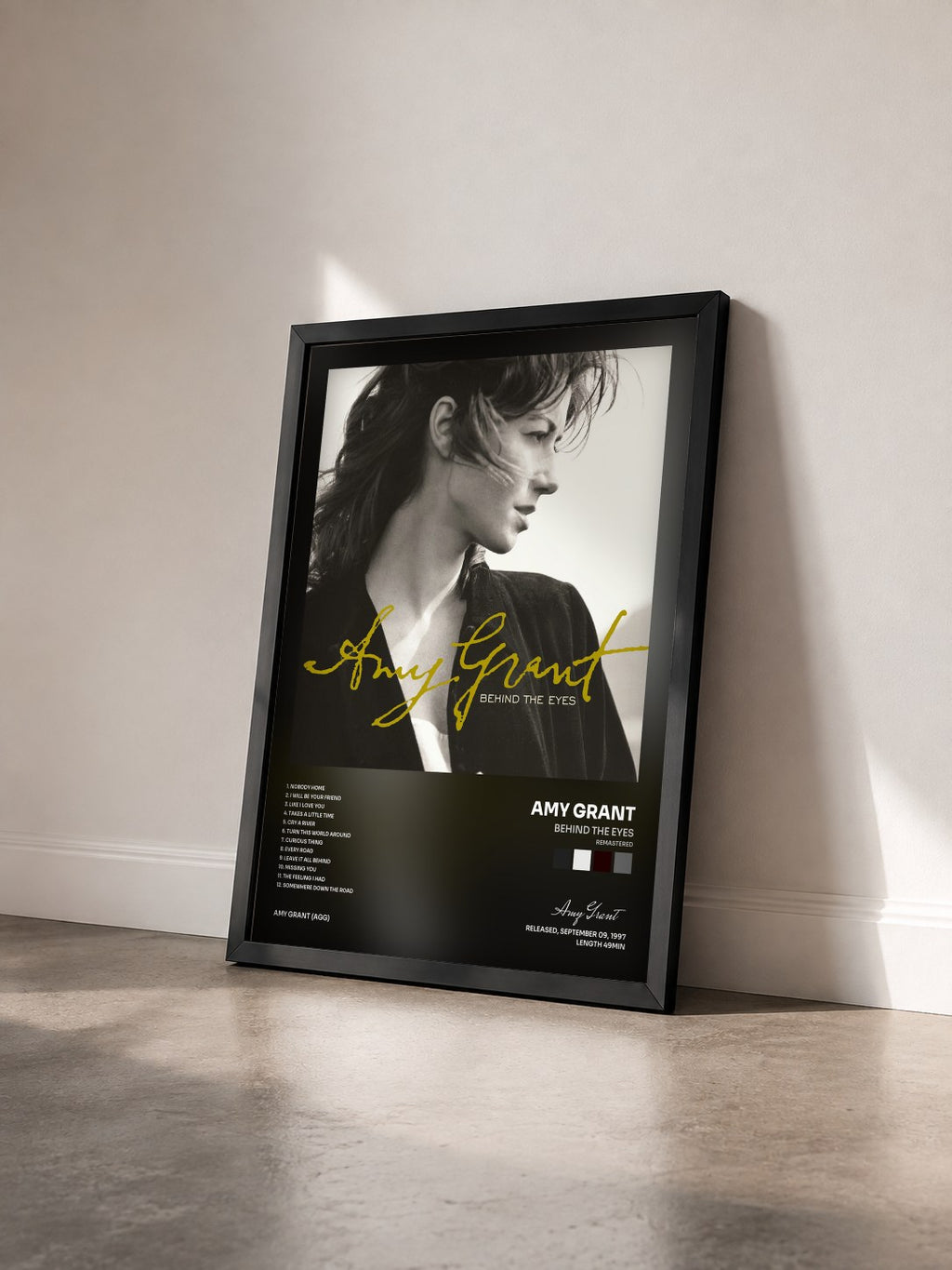 #noir Tableau de l'album Behind The Eyes (Remastered) de Amy Grant vu de trois quarts, cadre noir